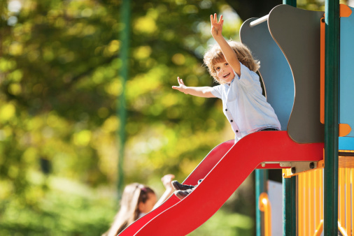 Little boy having fun while sliding.  