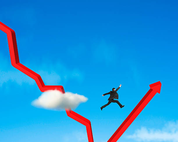 istock Businessman jumping over gowing down red arrow 483265321