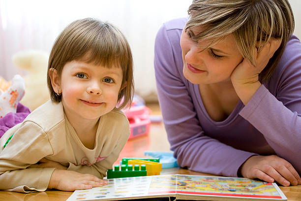istock Mother and child reading picture book 483265403