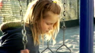 istock Sad young girl on swings 483265581