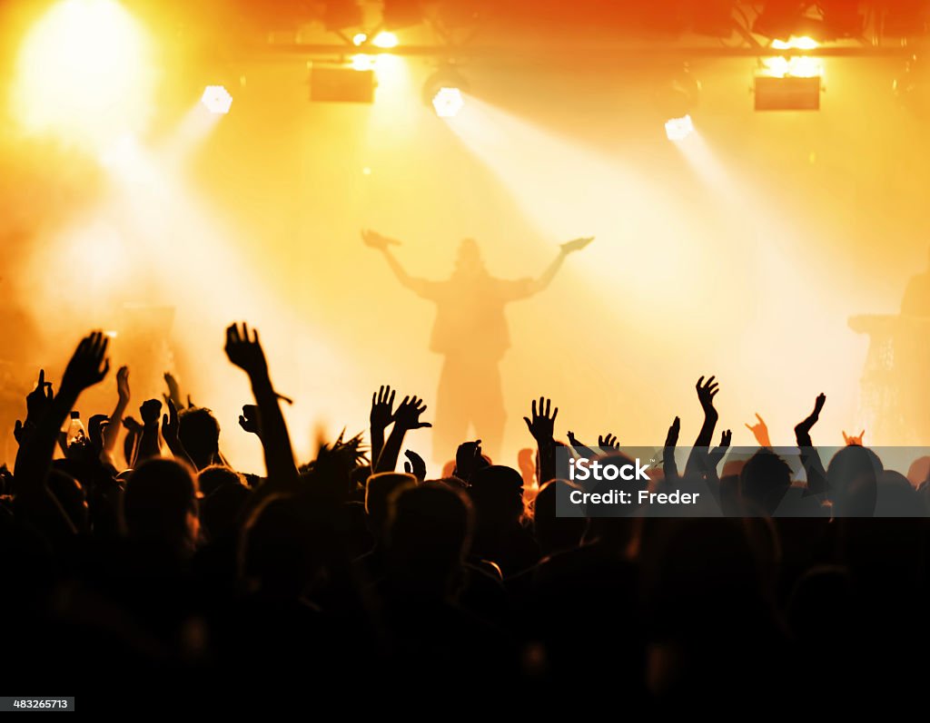 concert crowd silhouettes of people on a rock concert raising hands Music Festival Stock Photo