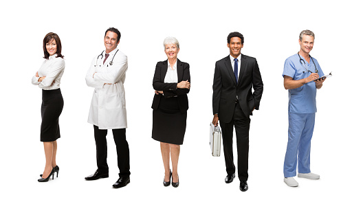 Smiling Business executives standing with medical staff isolated over white background