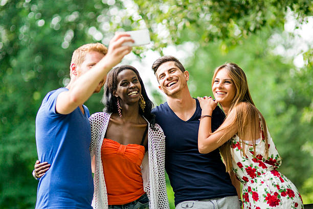 istock Group of young people and couples taking selfies in nature 483267224