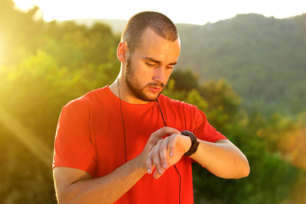 istock Sports man checking time on watch after workout 483271986