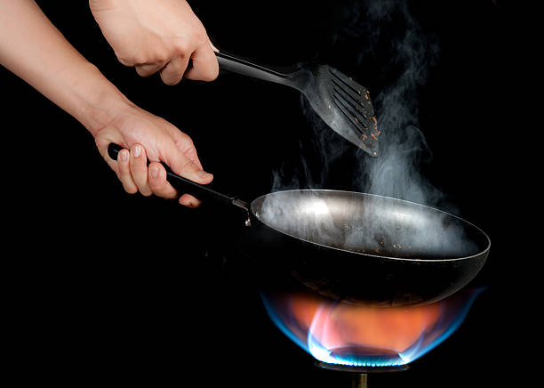 istock Chef cooking with flame in a frying pan 483275894