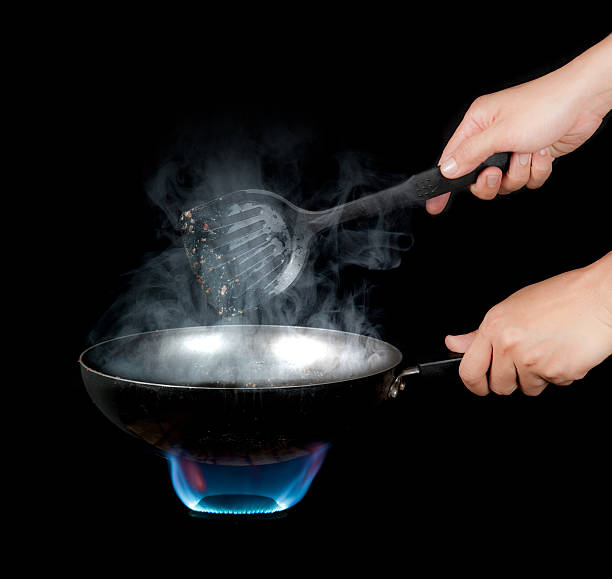 istock Chef cooking with flame in a frying pan 483275896