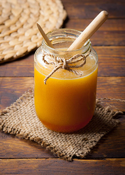 istock Honey drip in jar on the table 483277056