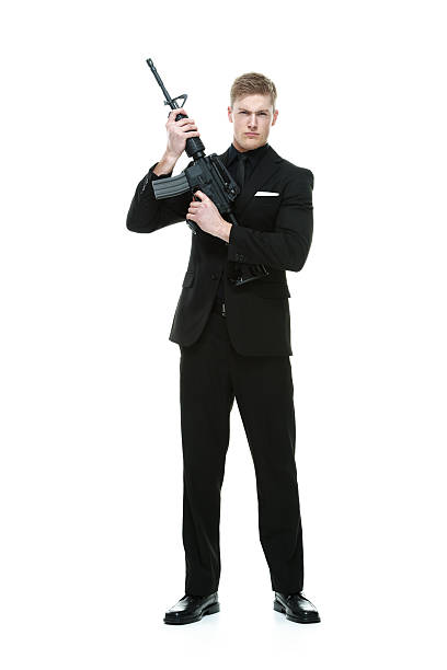 istock Angry businessman holding rifle 483277436