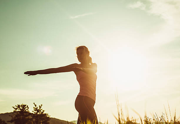 istock Young woman stretching in nature 483279980