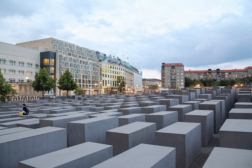 Berlin, Germany - May 31, 2023:  Holocaust Memorial in Berlin, Germany is a memorial in Berlin to the Jewish victims of the Holocaust, designed by architect Peter Eisenman and Buro Happold. It was inaugurated on 10 May 2005, sixty years after the end of World War II in Europe, and opened to the public two days later. It is located in the Mitte neighborhood one block south of the Brandenburg Gate.