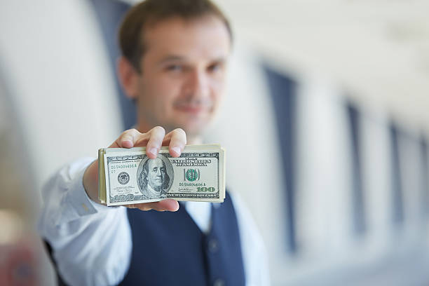 istock closeup money in male hands 483284292