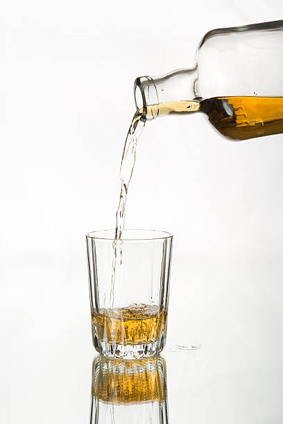 istock Single malt Scotch / whiskey pouring into glass. 483285646