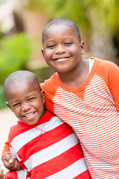 istock Happy young brothers hugging outdoors on sunny day 483286725