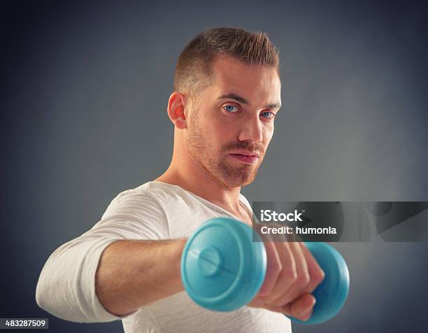 Handsome Man Holding Dumb Bells Stock Photo - Download Image Now - Activity, Adult, Adults Only
