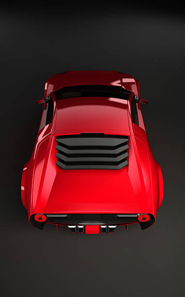 istock Sportscar in red on dark background from behind 483287517