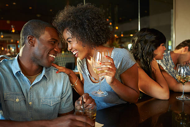 istock Couple Enjoying Drink At Bar With Friends 483287735