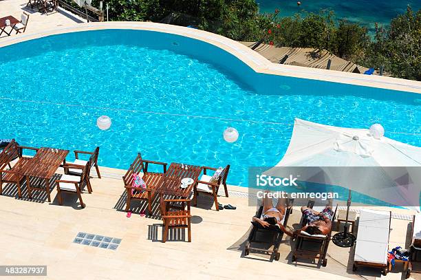 View Of A Couple Sitting On Deck Chairs Enjoying Vacation Stock Photo - Download Image Now