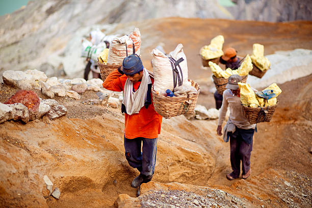 Indonesian workers in the crater of Ijen volcano stock photo