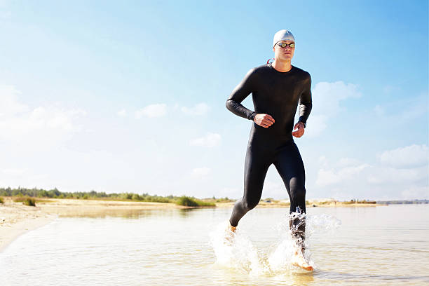 istock Triathlete running in to the water 483288445