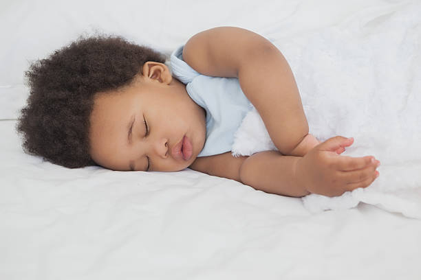 istock Cute little Afro baby sleeping in bed 483289729