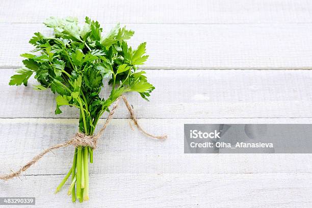 Bunch Of Parsley On White Boards Stock Photo - Download Image Now - Backgrounds, Bunch, Bundle