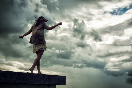 Young woman walking on a rooftop with her arms outstretchedhttp://195.154.178.81/DATA/i_collage/pi/shoots/781158.jpg