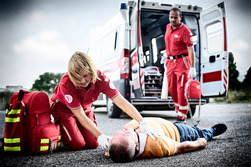 Paramedics succor a man with heart attack.