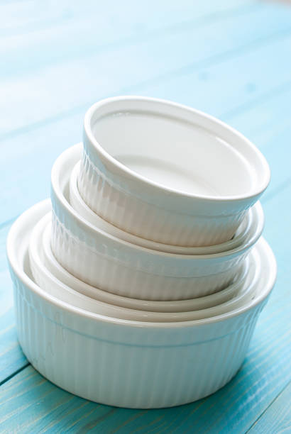 istock White Ramekin bowl on blue wooden board 483293034