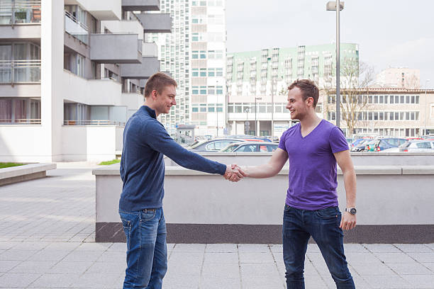 istock Happy young student giving a handshake to his classmate. 483293264