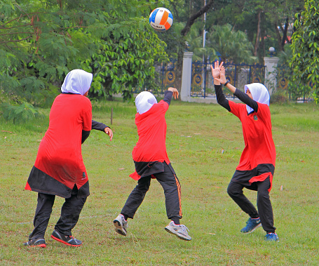 Shah Alam, Malaysia - April 1, 2015 schoolgirls are going to play volleyball in the public place on the street in Shah Alam, Malaysia on 1st April 2015