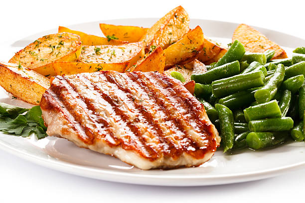 istock Grilled steak, baked potatoes and vegetables on white background 483293455