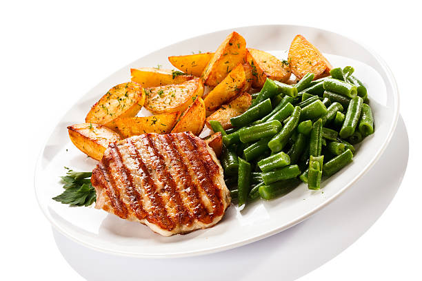 istock Grilled steak, baked potatoes and vegetables on white background 483293511