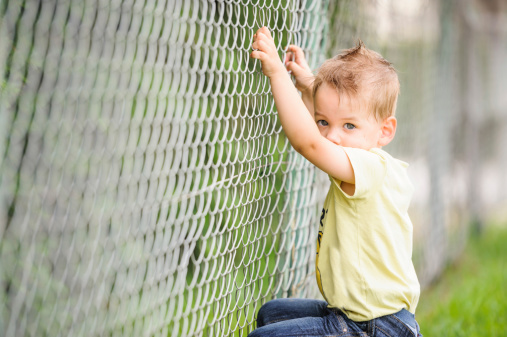 Child  near wire fence