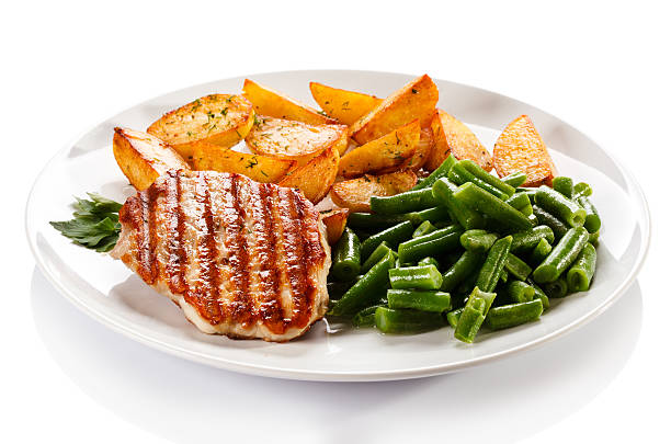 istock Grilled steak, baked potatoes and vegetables on white background 483293585