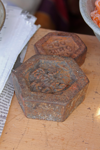 an old one kg & 500 gm hexagon shaped weight at indian market