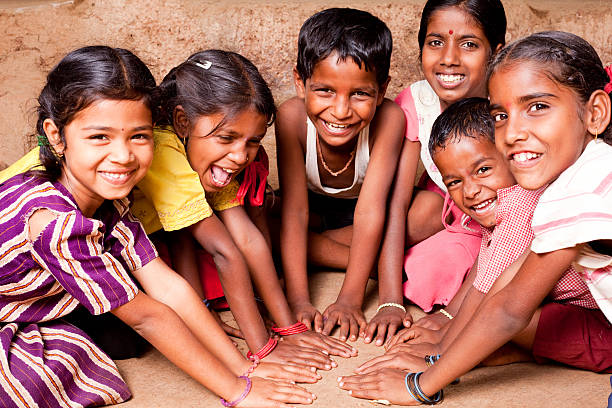 Cheerful Indian children playing in Maharashtra Group of Cheerful Rural Indian Children playing in a village in Maharashtra indian boy barefoot stock pictures, royalty-free photos & images