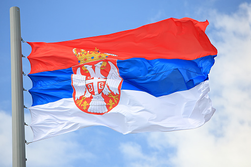 Flag of Serbia against the sky