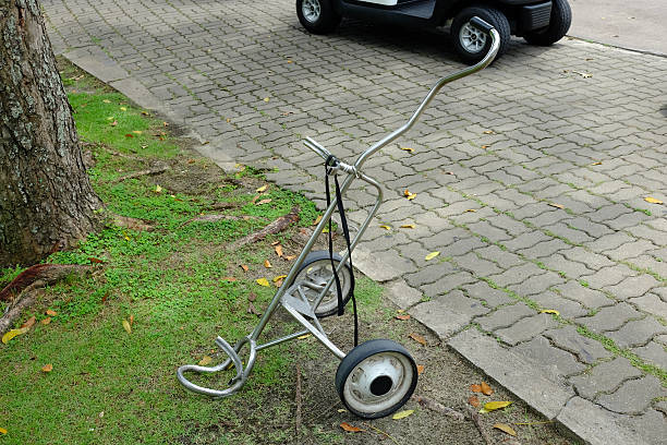 istock golf bag trolley and golf cart 483297652