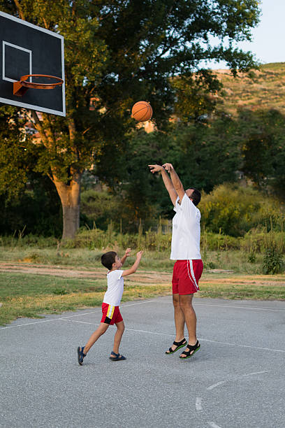 istock Father and son playing basketball 483297960
