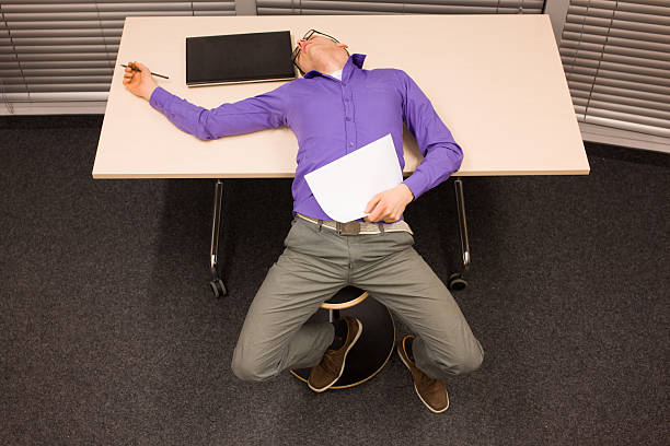 istock burnt out white collar worker laying on the table 483301884