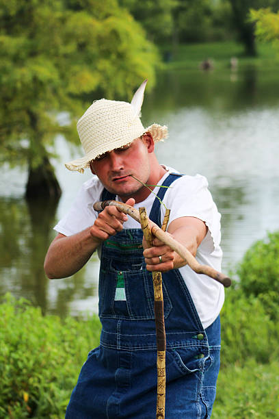 istock Man Wearing Overalls Holds Two Hiking Poles 483301948