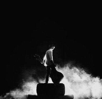 Rock concert stage. Guitarist playing on electric guitar.