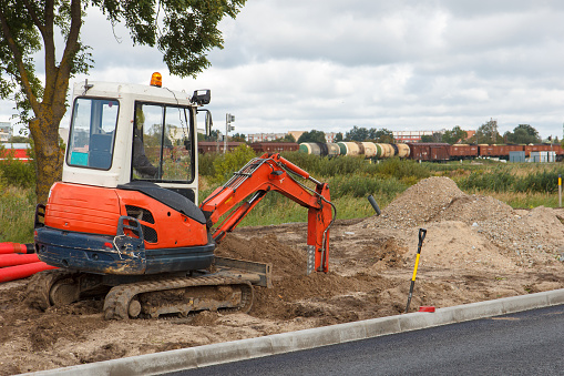 An excavator in a road construction site 