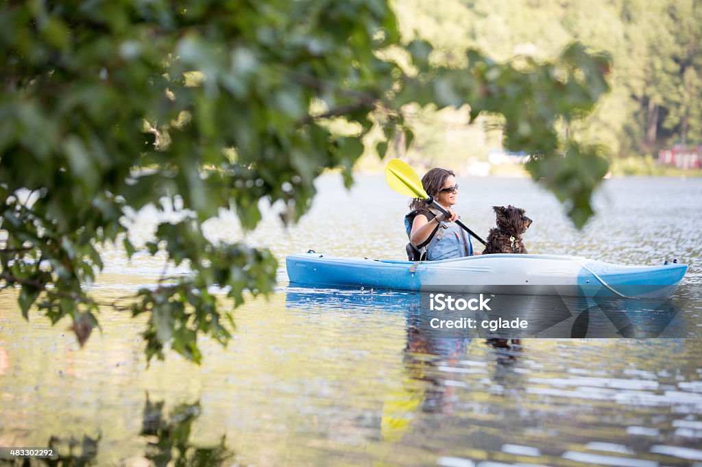 Young Woman and Pet in Kayak Young Woman Vacationing with her Dog Dog Stock Photo