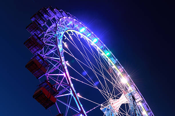 istock Ferris wheel with multi-colored illumination against night sky 483302988
