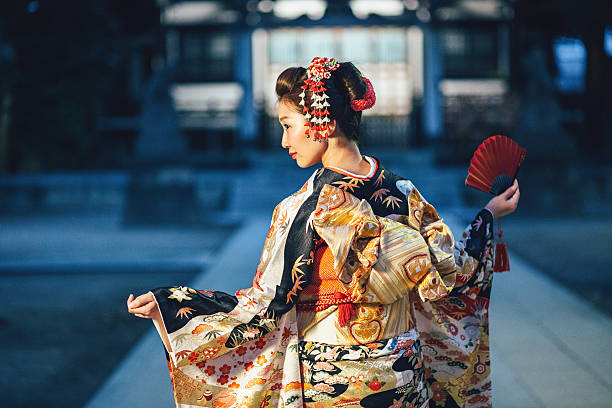 Portrait of young woman with kimono in Japan Woman in traditional japanese clothes and hand fan kimono stock pictures, royalty-free photos & images