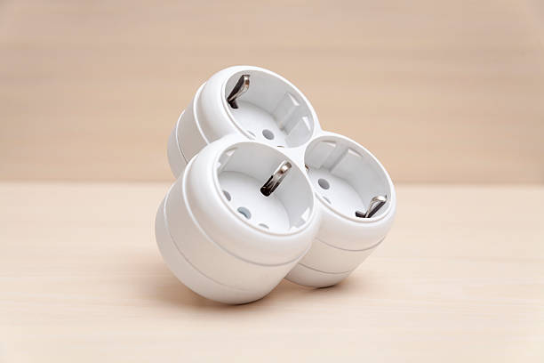 istock Triple Cordless Power Outlet Plug on a Wooden Surface 483303934