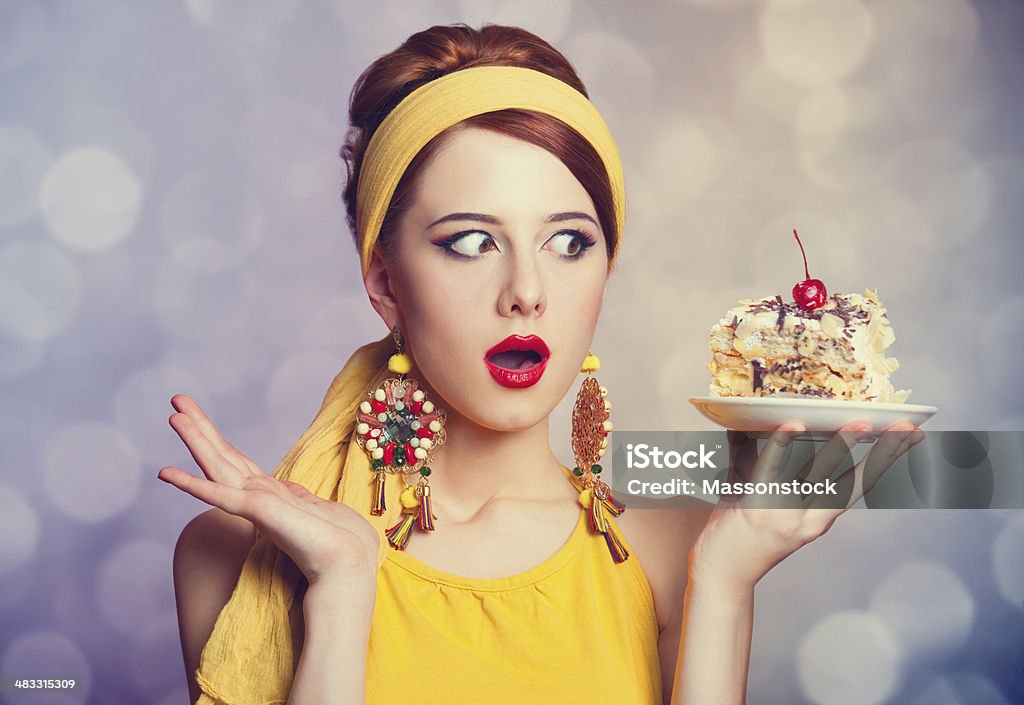 Style redhead girl with cake. Style redhead girl with cake. Photo with bokeh at background. Women Stock Photo