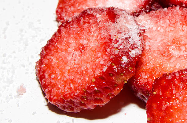 sliced strawberries with sugar stock photo