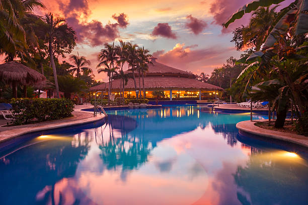 piscina de lujo en un complejo turístico tropical al atardecer - lugar turístico fotografías e imágenes de stock